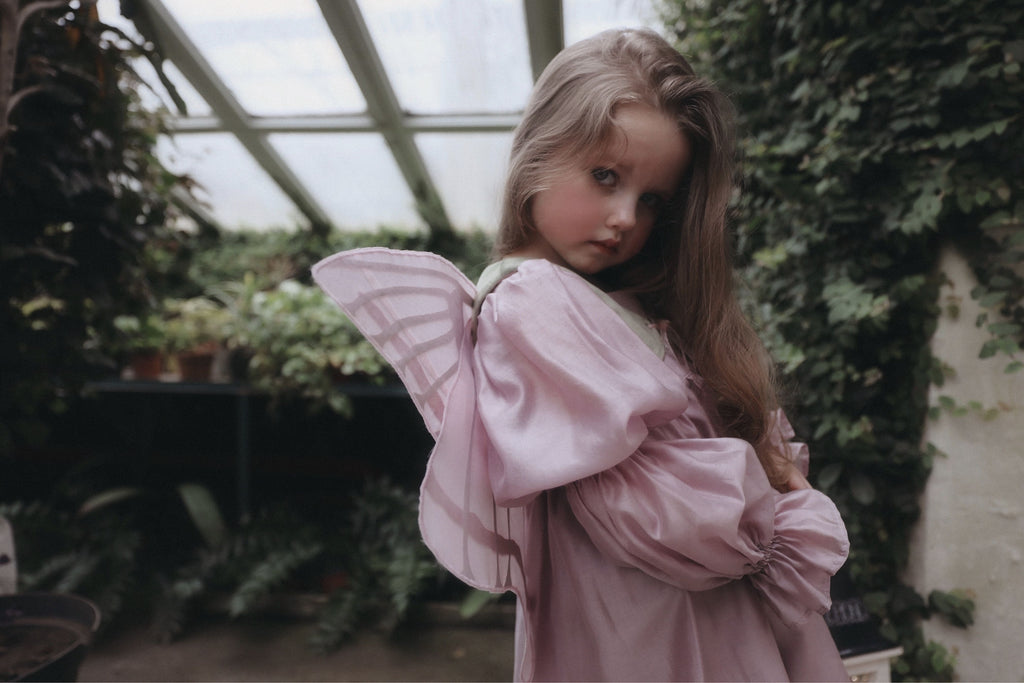 Крила на жилетці зелено-рожеві